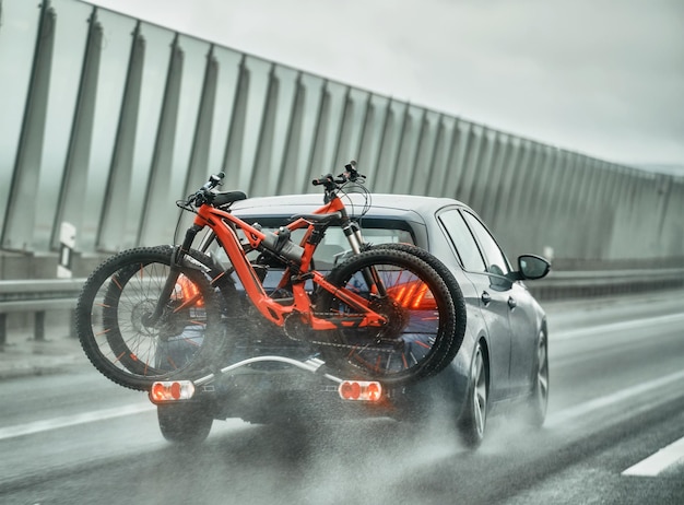 Crossover SUV car with two mountain bicycles loaded on a rack