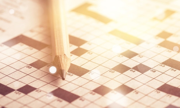 Photo crossword puzzle and pencil on background