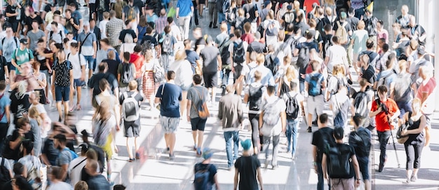 Crowd of anonymous people at a trade fair hall