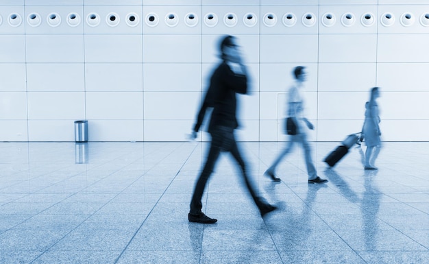 crowd of blurred business people walking at a floor. ideal for websites and magazines layouts