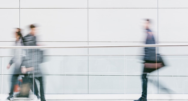 crowd of business people walking in a modern hall, including copy space. ideal for websites and magazines layouts