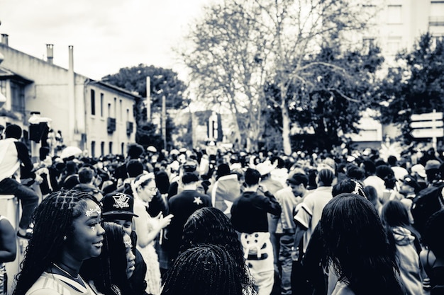 crowd captivated by smartphone screen on city street montpellier carnival
