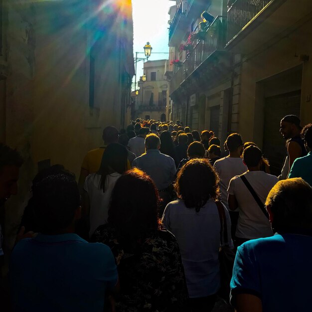 crowd in city against sky