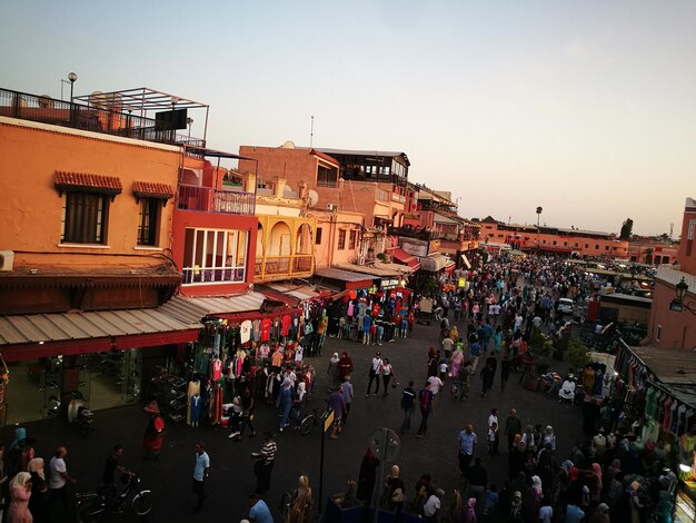 Crowd at market in city against clear sky