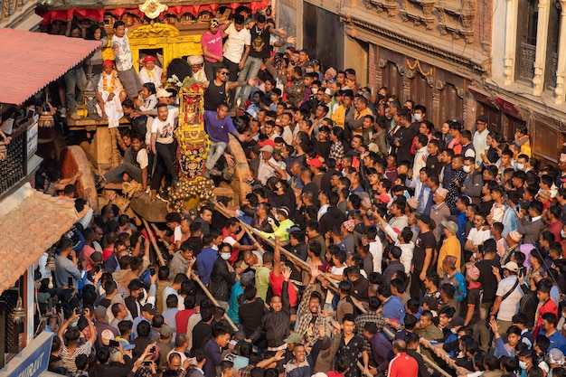 A crowd of people are gathered in a crowded street.