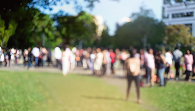 The crowd of people in a city nature park blurred background