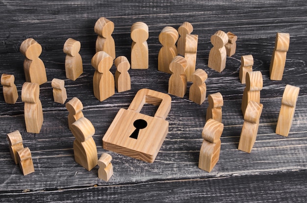 A crowd of people stands and looks at the padlock in the center. 