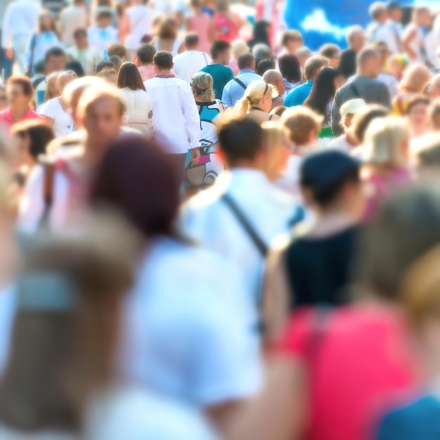 Folla di persone che camminano sulla strada trafficata della città.