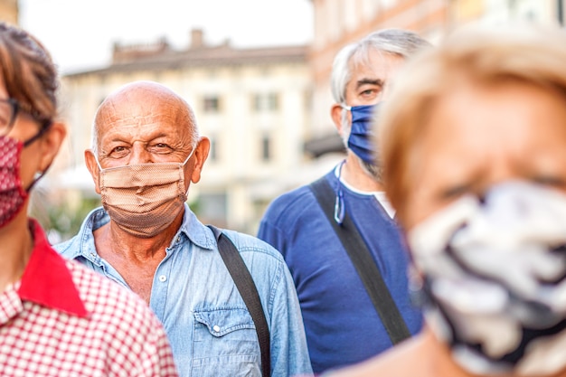 Crowd of people walking down the city streets with face mask