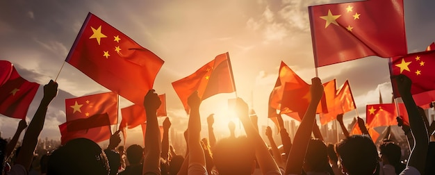 Crowd of people waving the flags of China in the sunset