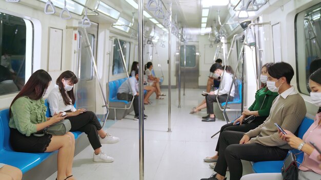 Crowd of people wearing face mask on a crowded public subway train travel