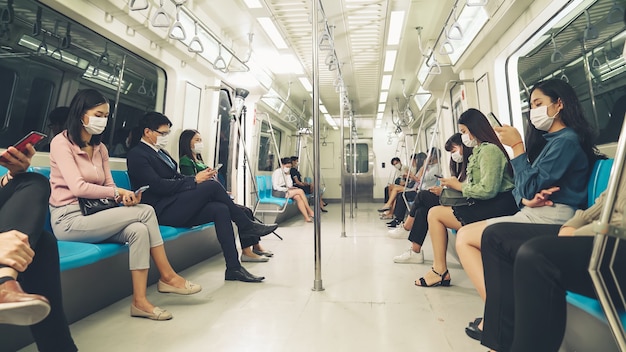 Crowd of people wearing face mask on a crowded public subway train travel