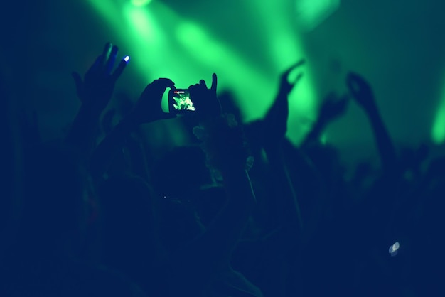 Crowd with arms outstretched at concert