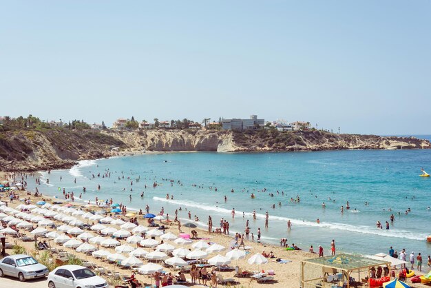 Crowded summer beach with unrecognizable tourists