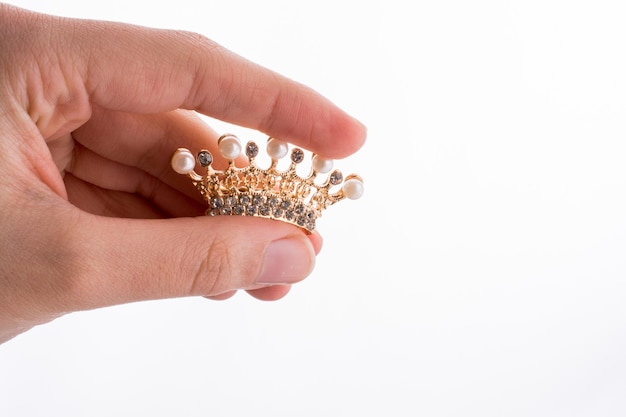Crown model with pearls in hand