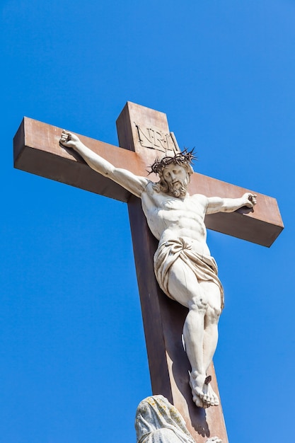 Crucifix made of marble with blue sky in background. France, Provence Region.