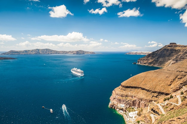 Cruise liner near the Greek Islands. Bright turquoise sea and blue sky. Santorini island, Greece