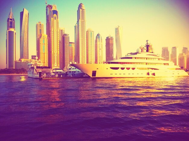 Cruise ship at harbor with city in background