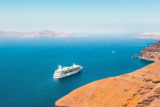 Cruise ship near the sea coast of Santorini island, Greece. Summer landscape