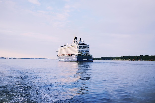 Cruise ship sailing in river against sky