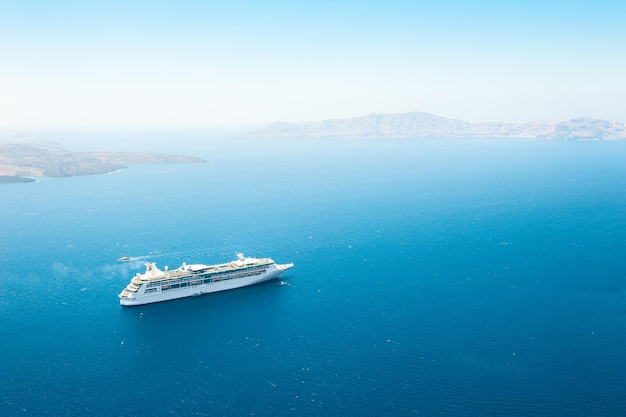 Cruise ship in the sea near the Santorini island, Greece.