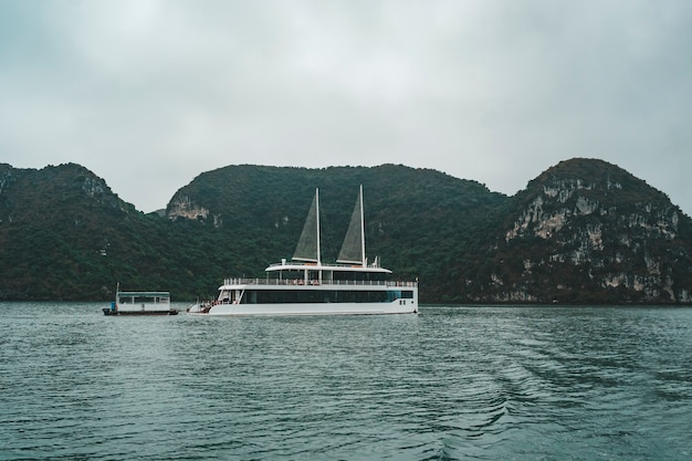 Cruising among beautiful limestone rocks and secluded beaches in Ha Long bay, UNESCO world heritage site, Vietnam.