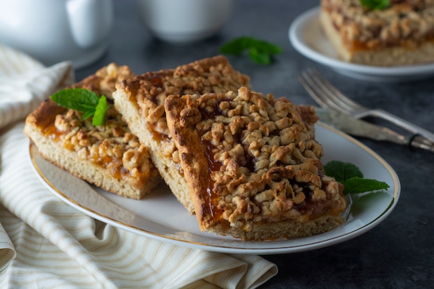 Crumble fruit pie, slice. Homemade cake with fruit jam. Delicious desert.