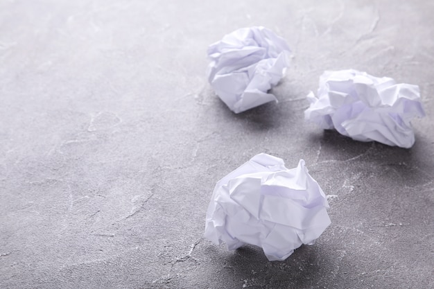 Crumbled paper on a grey concrete