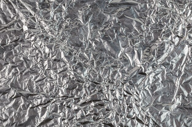 Crumpled aluminium foil flat background and texture