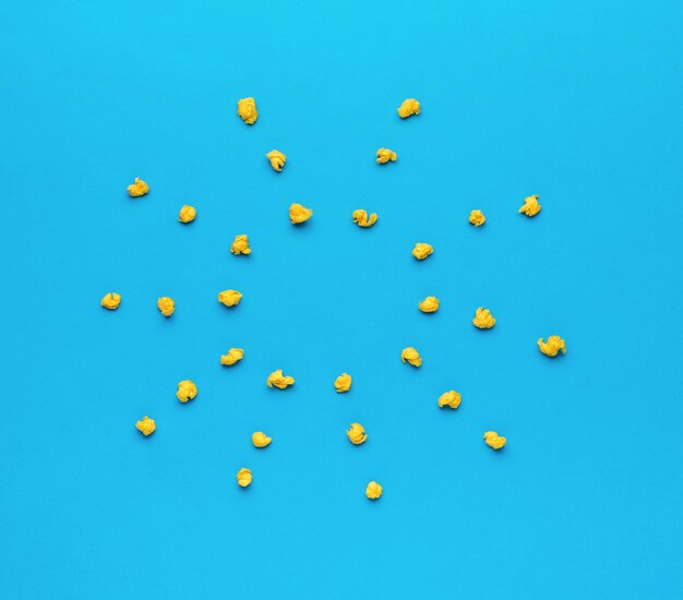 Crumpled balls of paper in the form of a sun on a blue background Minimal business concept