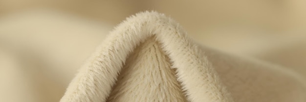 Crumpled beige terry cloth with short fur in fabric store macro view textile material prepared