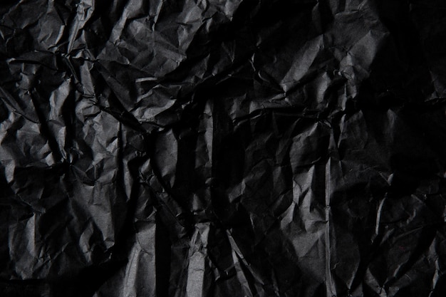 Crumpled black paper texture.