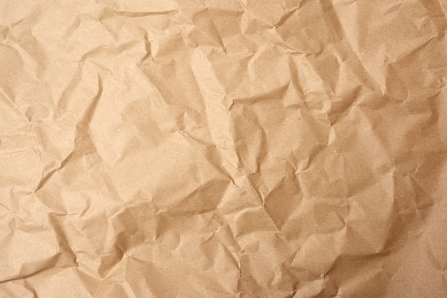 Crumpled blank sheet of brown wrapping kraft paper