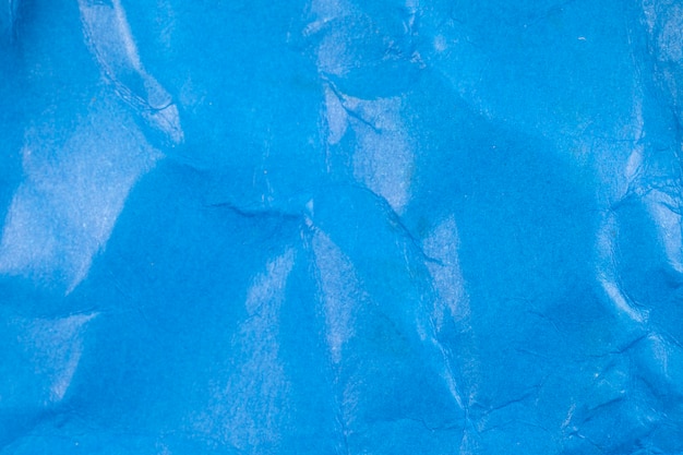 Crumpled blue paper background.