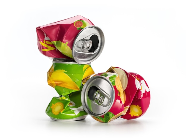 Crumpled bright aluminum soda cans on white studio shot Ecology the concept of recycling and envi