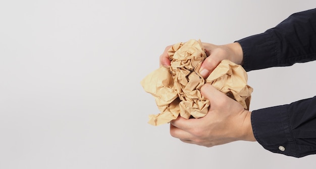 Crumpled brown paper.It is mauled in man hand on white background.