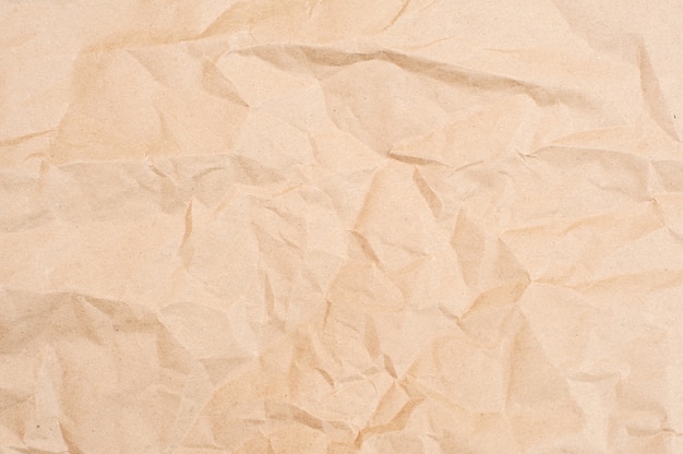 Crumpled brown paper texture. Brown background