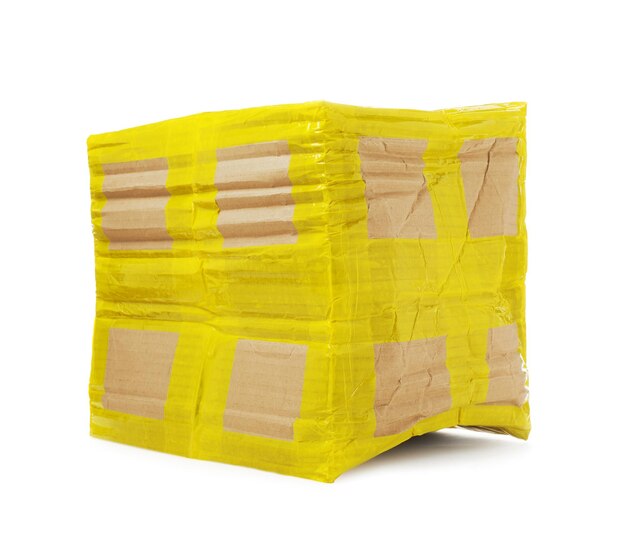 Crumpled cardboard parcel box with yellow sticky tape on white background