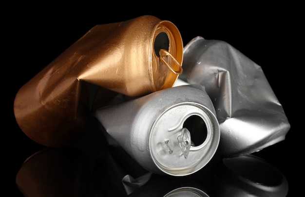 Crumpled empty can isolated on black