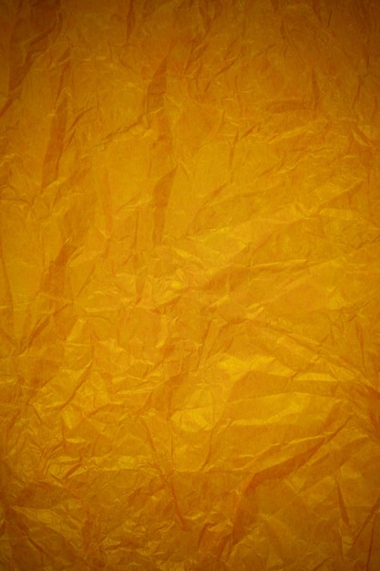 Crumpled gold paper recycling background.