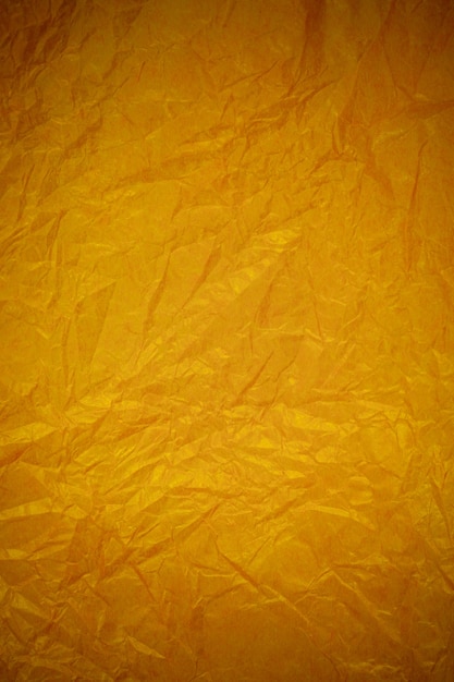 Crumpled gold paper recycling background.