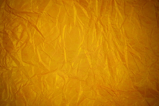 Crumpled gold recycling paper background