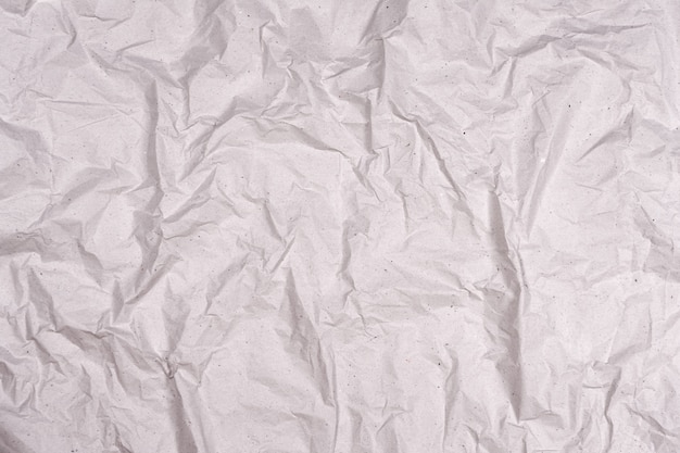 Фото Мятую текстуру серой бумаги. фон морщинистой бумаги с трещинами и изломами.