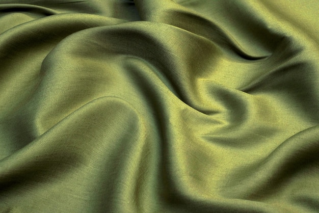 Crumpled green fabric texture, wavy wrinkled cloth. soft linen fabric background.