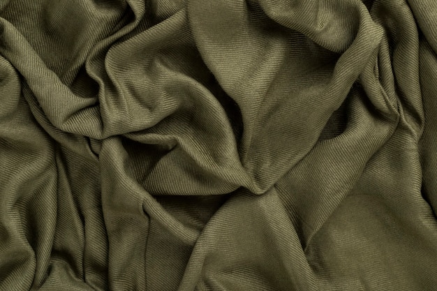 Crumpled linen cloth texture. Wrinkled textile. Green.