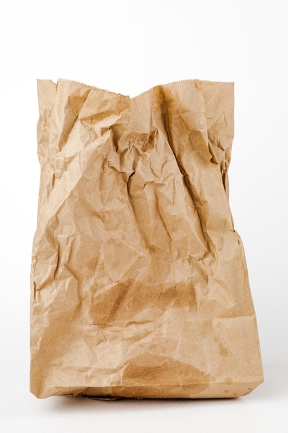 Photo crumpled paper bag with greasy spots on a white isolated background recycling of secondary waste