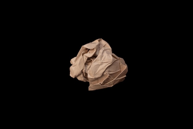 Crumpled paper ball isolated on black background