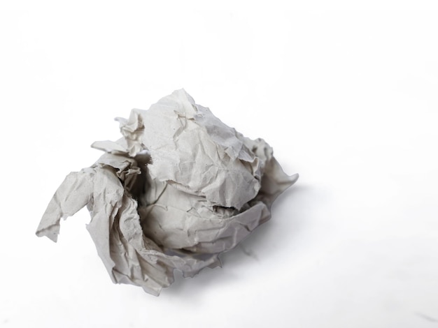 Crumpled paper ball thrown out idea notes into trash garbage concept isolated on white