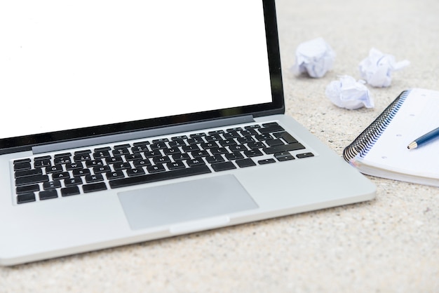 Crumpled paper, notebook, computer and pencil