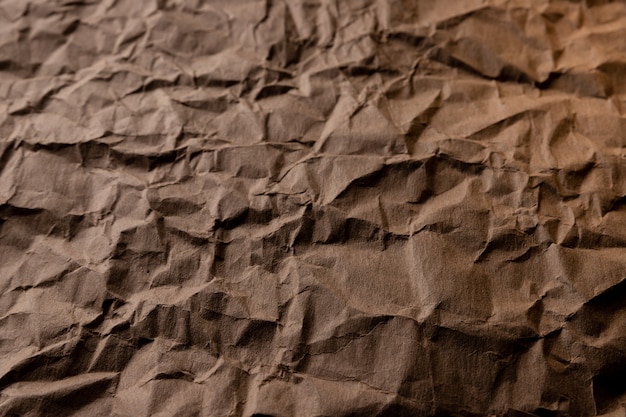 Crumpled paper. sheet of brown cardboard paper. detailed high resolution texture. abstract background for wallpaper.